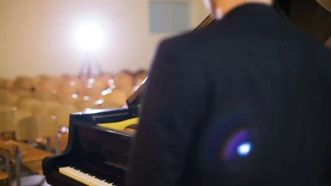 Making music. Profile of a handsome man playing piano Stock Footage 77525027