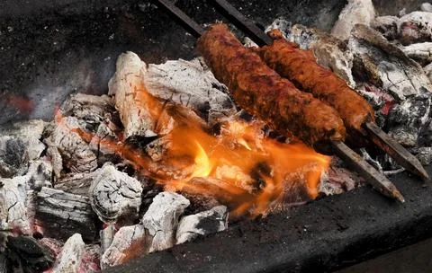 Making mutton kababs or kebabs on coal fired arrangement Stock Photos