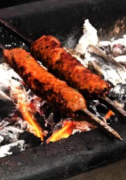 Making mutton kababs or kebabs on coal fired arrangement Stock Photos
