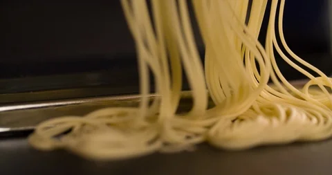 Making Noodle Spaghetti in Hand pasta machine cooking food 4K video Stock Footage 104049708