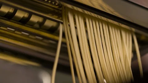 Making Noodle Spaghetti in pasta machine Closeup Slow motion Stock Footage 104063400