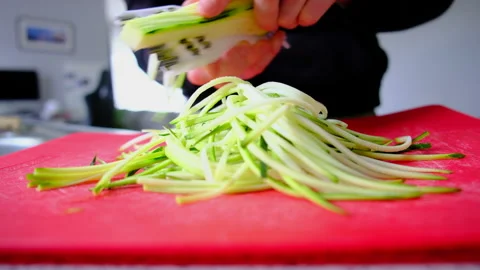 Making noodles with courgette zucchini in the kitchen Stock Footage 246429396