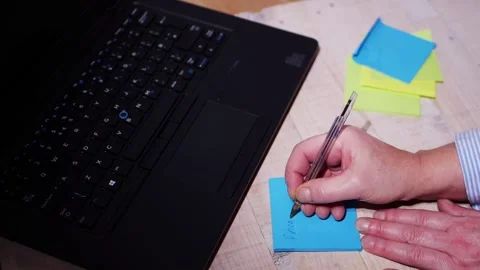 Making notes in an office on notepad Stock Footage 175880781