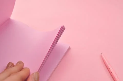 Making notes in pink notebook copy space Stock Photos