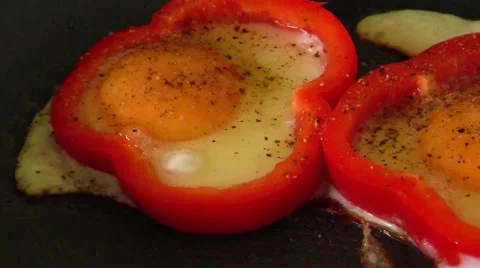 Making omelet fried egg  in red sweet pepper ring Stock Footage 68864153