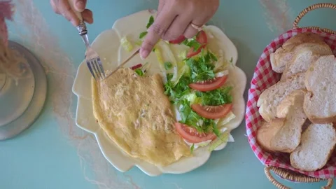Making an omelette with fresh vegetables on a plate Stock Footage 335567140