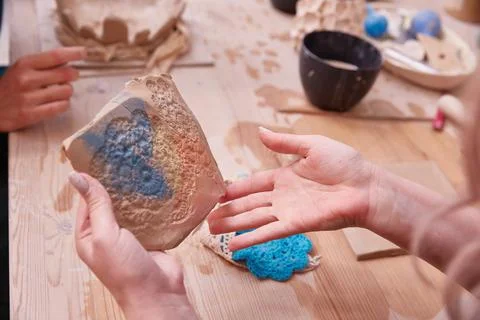 Making an openwork panel made of clay with a knitted napkin Stock Photos