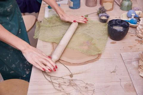 Making an openwork panel made of clay with a knitted napkin Stock Photos