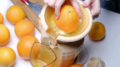 Making orange juice pressing half of orange. Close up of hands squeezing orange Stock-Footage 336588886