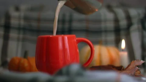Making Orange Pumpkin mug of tea on warm candlelight background Stock Footage 323121286