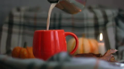 Making Orange Pumpkin mug of tea on warm candlelight background Stock Footage 323123641