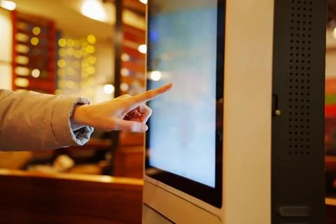 Making an order on touch screen menu in cafe. Stock Photos