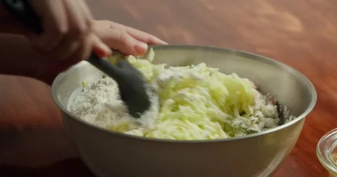 Making pancakes from grated zucchini. Close-up of zucchini fritters frying in Stock Footage 317072631