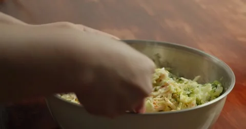 Making pancakes from grated zucchini. Mixing all ingredients in a special bowl Stock Footage 325995013
