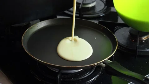 Making pancakes. pancake batter being poured into a hot pan Stock Footage 170792238