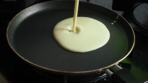 Making pancakes. pancake batter being poured into a hot pan Stock Footage 170792272