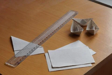 Making paper boat using scale and paper pieces Stock Photos
