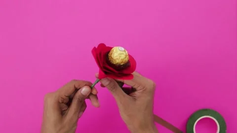 Making a paper red rose flower with chocolate in the center 003 Stock Footage 168727469