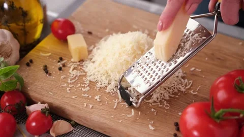 Making pasta carbonara - grating parmesan cheese on wooden cutting board Stock Footage 201509461