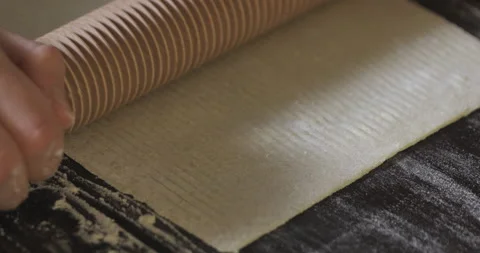 Making pasta by cutting dough with rolling pin. Stock Footage 138694148