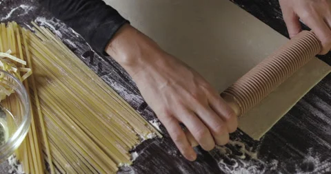 Making pasta by cutting dough with rolling pin. Stock Footage 138694847