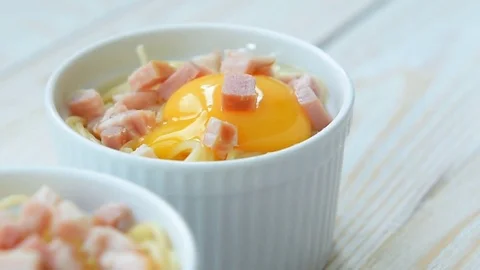 Making pasta with egg and bacon Stock Footage 69748879