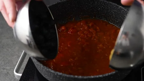 Making pasta sauce base, frying pan and olives with olive oil Stock Footage 231415546
