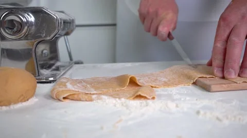 Making pasta, slicing dough for making homemade pasta, close-up, 4K Stock Footage 132464618