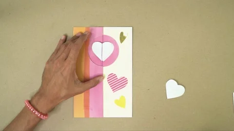 Making pastel-colored valentine card for scrapbook project, overhead shot, Stock Footage 289362853
