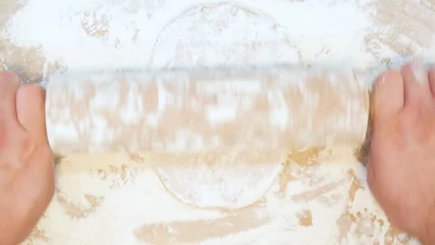 Making pastry dough for ginger cookies. A baker rolling a dough between sheets Stock Footage 269835209