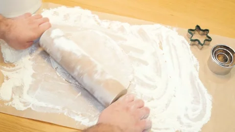 Making pastry dough for ginger cookies. A baker rolling a dough between sheets Stock Footage 270345706