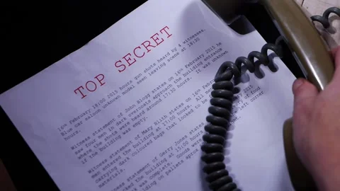 Making a phone call about top secret information in dark room Stock Footage 179590896