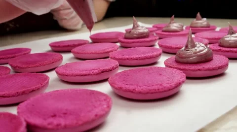 Making pink Macarons, add filling from the cooking bag Stock Footage 62426237