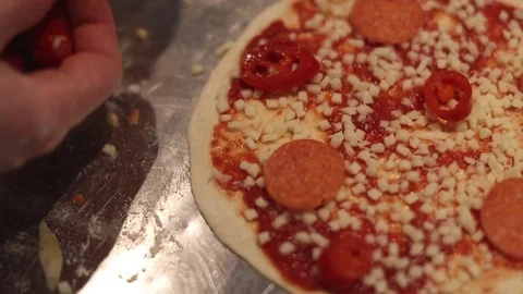 Making a Pizza - Adding Chilli Peppers Stock Footage 77225665