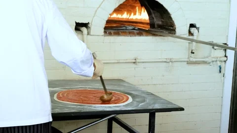 Making pizza base greased with tomato sauce Stock Footage 153608339