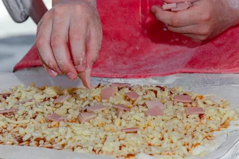 Making pizza: close-up of children's hands and pizza Stock Photos