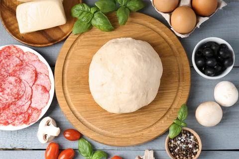 Making pizza. Different ingredients on gray wooden table, flat lay 写真素材
