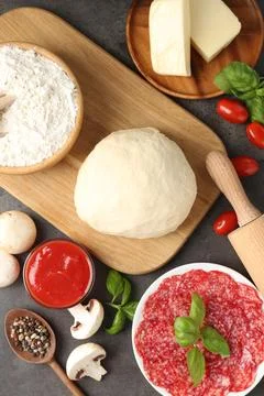 Making pizza. Different ingredients on gray textured table, flat lay 写真素材