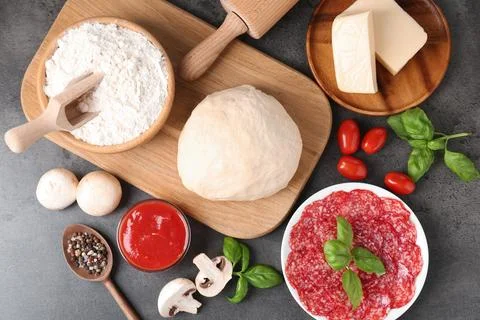 Making pizza. Different ingredients on gray textured table, flat lay 写真素材