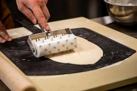 Making Pizza Dough on Table in Professional Gourmet Kitchen Stock Photos