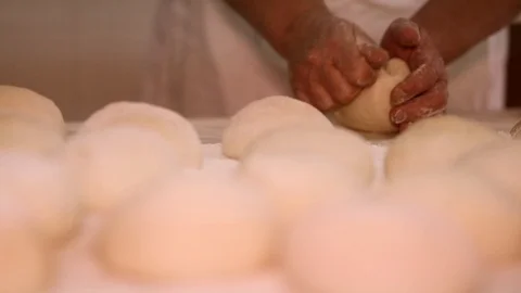 Making pizza or pide dough by close up male hands in pastry kitchen. Shaping dou Stock Footage 90730981