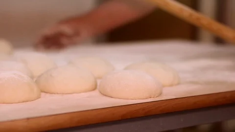 Making pizza or pide dough by close up male hands in pastry kitchen. Shaping dou 動画素材 90734075