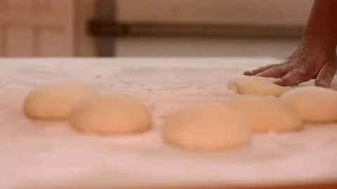 Making pizza or pide dough by close up male hands in pastry kitchen. Shaping dou Stock Footage 90735269