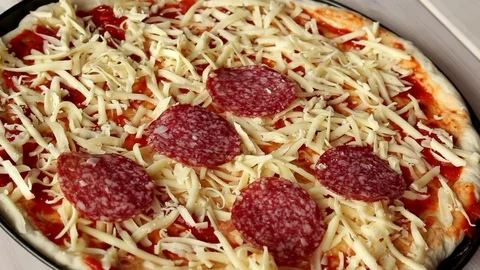Making pizza, putting salami, pepperoni on pizza Stock Footage 72458863