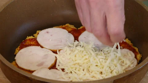 Making Pizza, putting shredded cheese on pizza dough with tomato sauce and ham Stock Footage 217451229