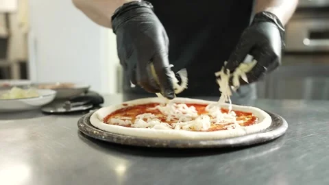 Making Pizza in Restaurant Kitchen Stock Footage 328952771