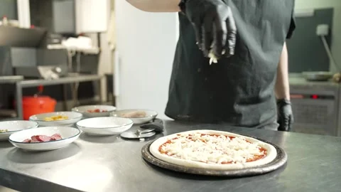 Making Pizza in Restaurant Kitchen Stock Footage 328952777