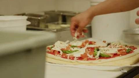 Making pizza shredded mozzarella cheese on pizza italian restaurant kitchen Stock Footage 238961133