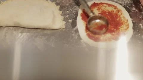 Making a Pizza - Spreading the Tomato Puree Stock Footage 68978677