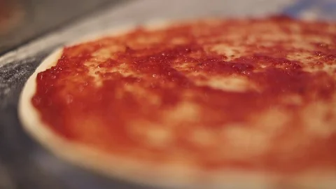 Making a Pizza - Spreading the Tomato Puree Stock Footage 77225621